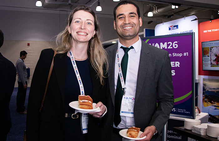 Two people posing with food smiling at camera